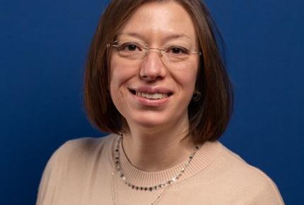 Headshot of researcher Professor Roberta Tasso in front of a blue background