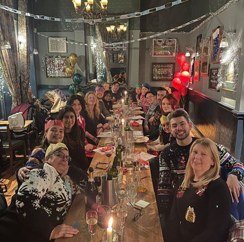 Claire Fletcher and her team enjoying a meal out together at Christmas